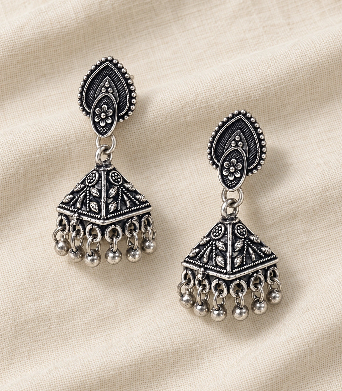 JIMIKI Oxidized Silver Teardrop Stud Floral Pyramid Jhumka Earrings in Oxidized Silver - editorial flatlay #color_oxidized-silver