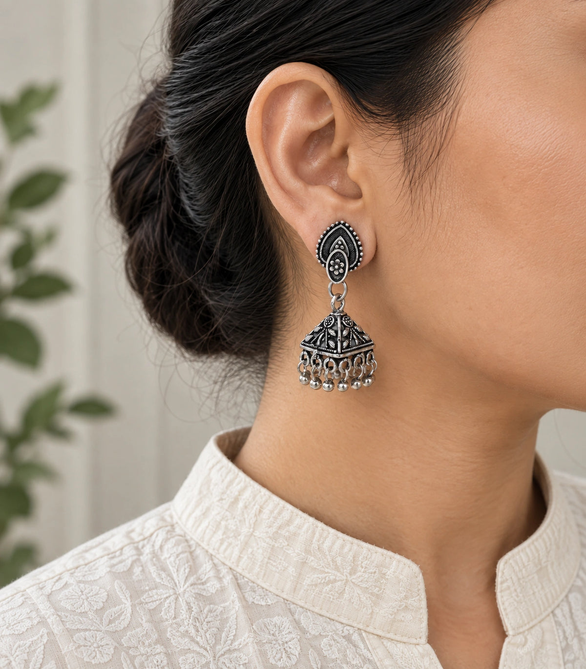 JIMIKI Oxidized Silver Teardrop Stud Floral Pyramid Jhumka Earrings in Oxidized Silver - worn styling view #color_oxidized-silver
