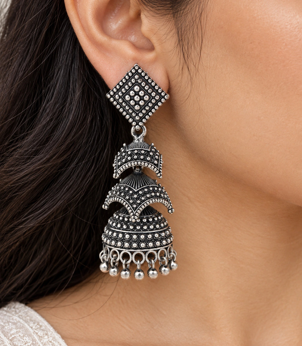 JIMIKI Oxidized Silver Tiered Chevron Jhumka Earrings - close-up of the stud, tier and bead details #color_oxidized-silver