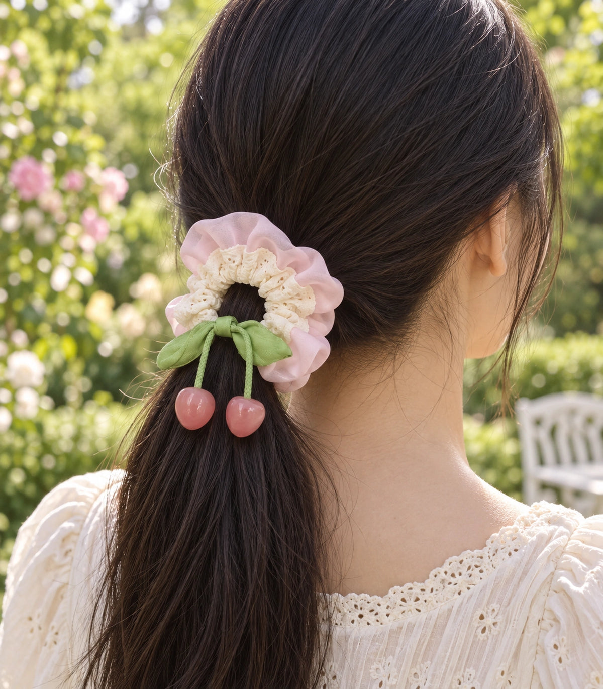 JIMIKI Lace Scrunchie With Cherry Charms in Pale Pink, editorial model view #color_pale pink