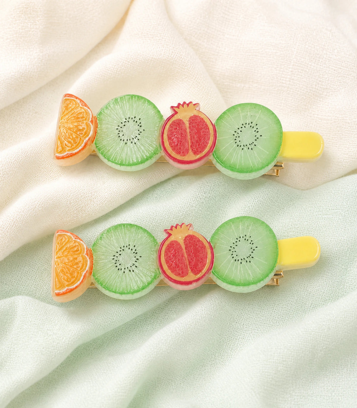 Editorial flat lay of the Pastel Citrus Mint Kiwi Pomegranate Barrette Pair