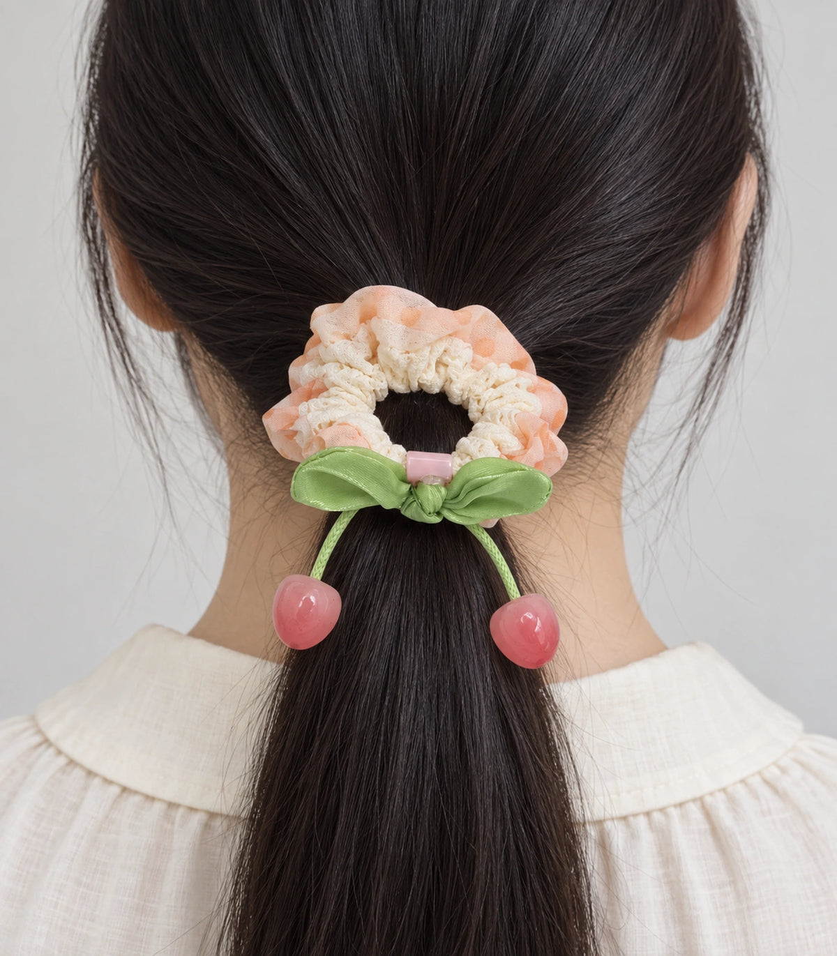 JIMIKI Polka Dot Lace Scrunchie With Cherry Charms in Peach, model wearing view #color_peach