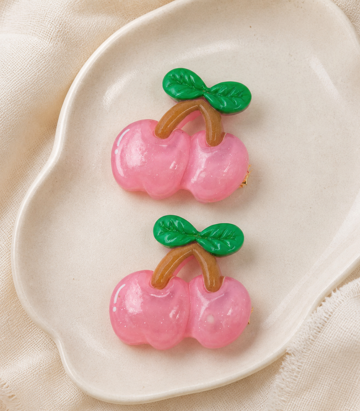 Pink Cherry Barrette Pair editorial flat lay