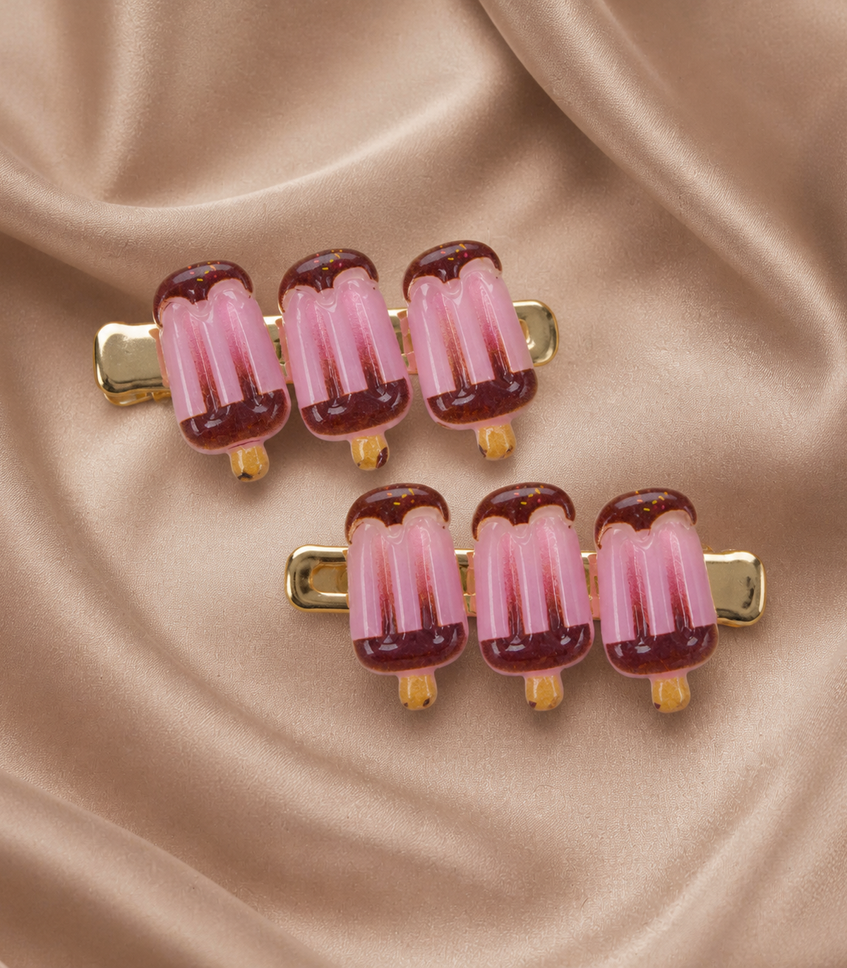 Pink Chocolate Iced Pop Trio Clip Pair in an editorial flat lay