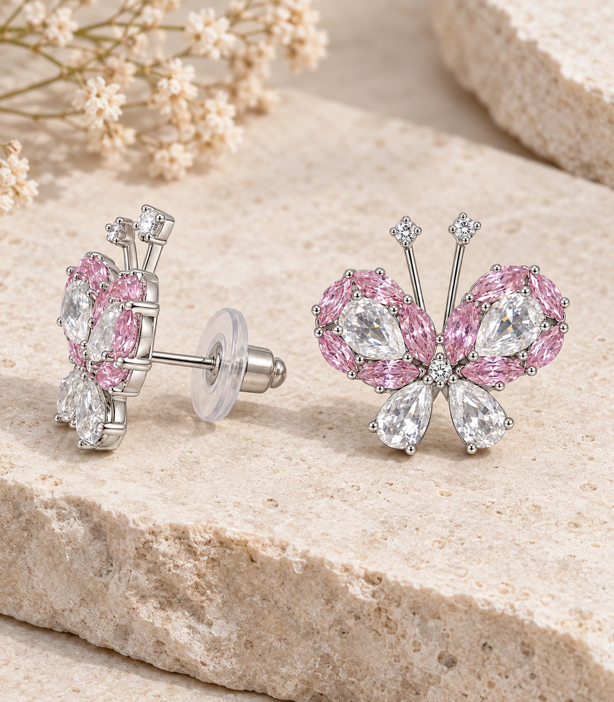 JIMIKI Crystal Butterfly Stud Earring Pair in Pink / silver tone, editorial flat lay #color_pink / silver tone