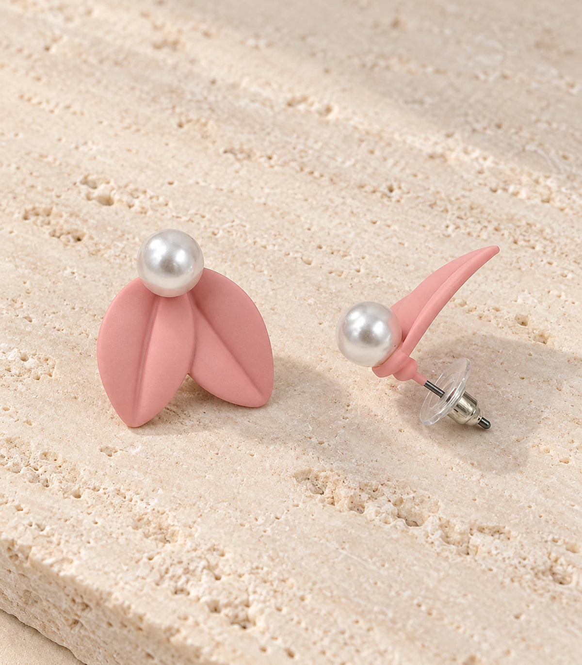 JIMIKI Double Leaf Pearl Stud Earrings in Pink — pair in a styled flat lay #color_pink