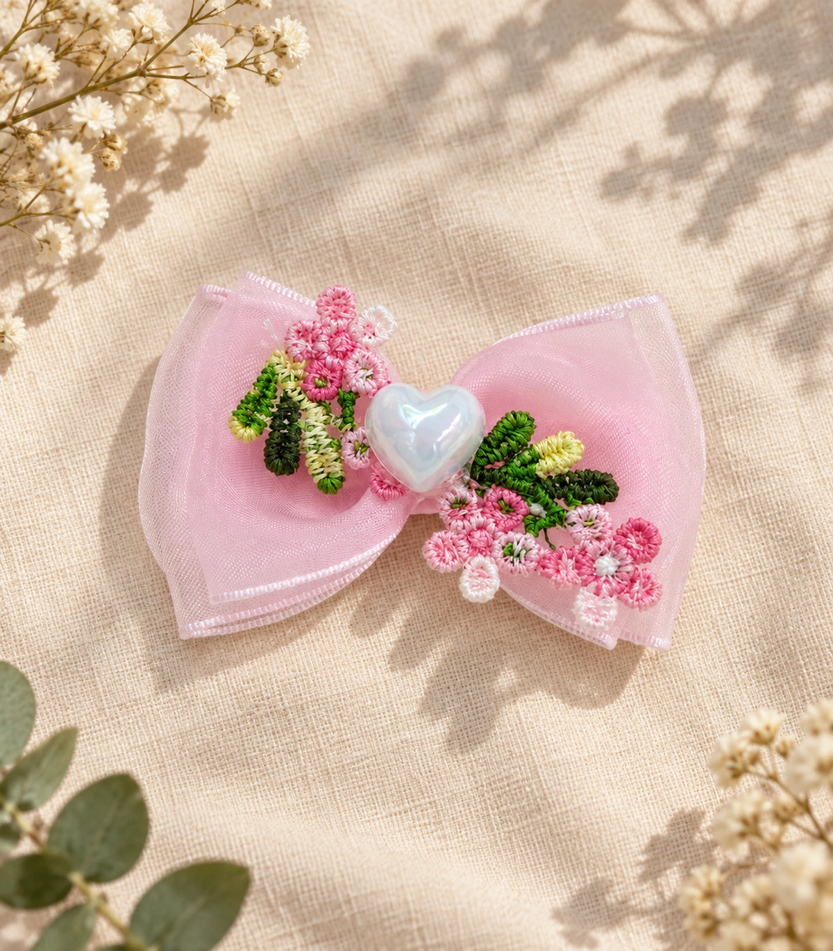 JIMIKI Pink Floral Pearl Heart Bow Hair Clip in Pink / Multicolor, editorial flat lay