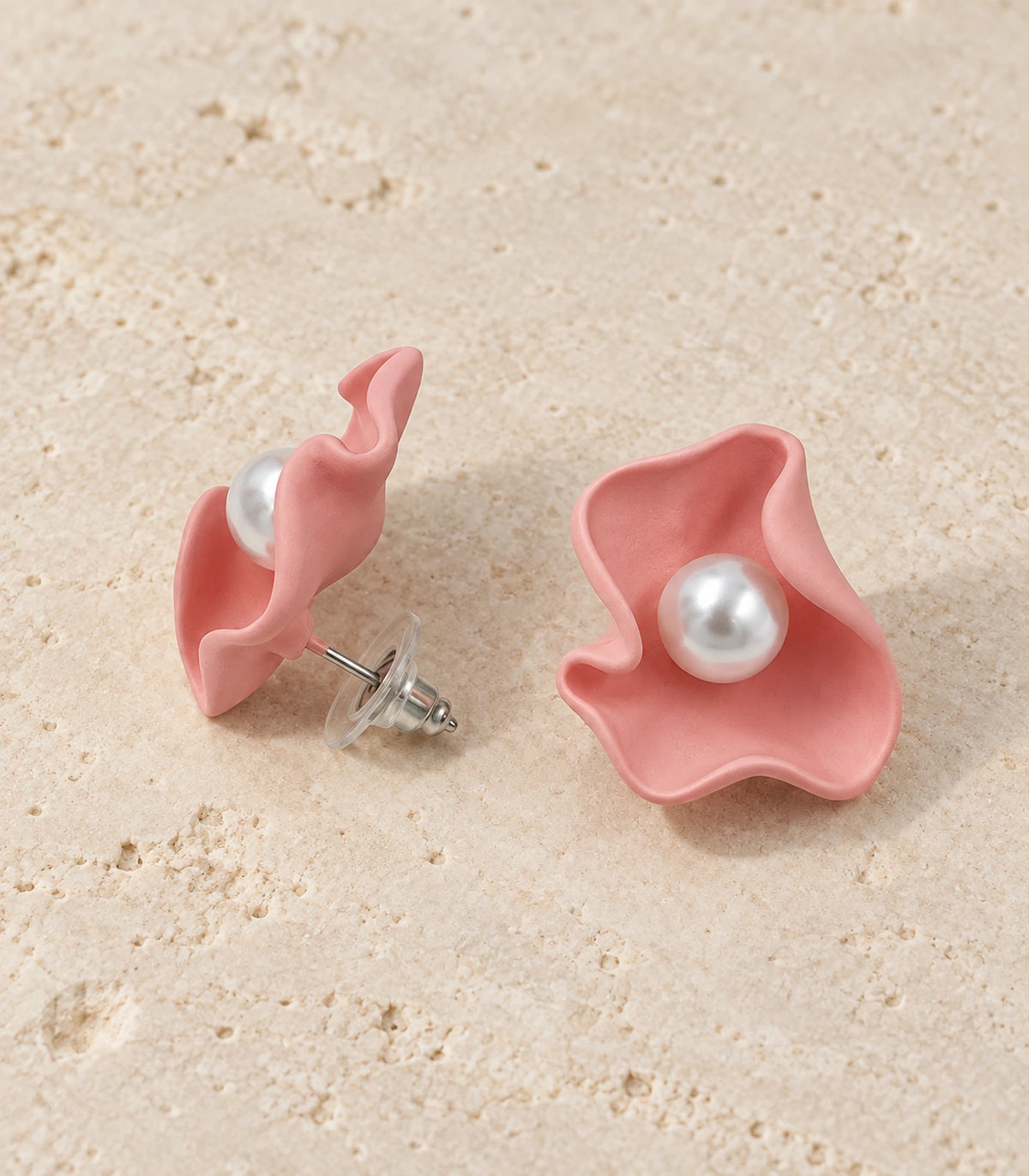 JIMIKI Folded Calla Pearl Stud Earrings, Pink — pair in a styled flat lay #color_pink