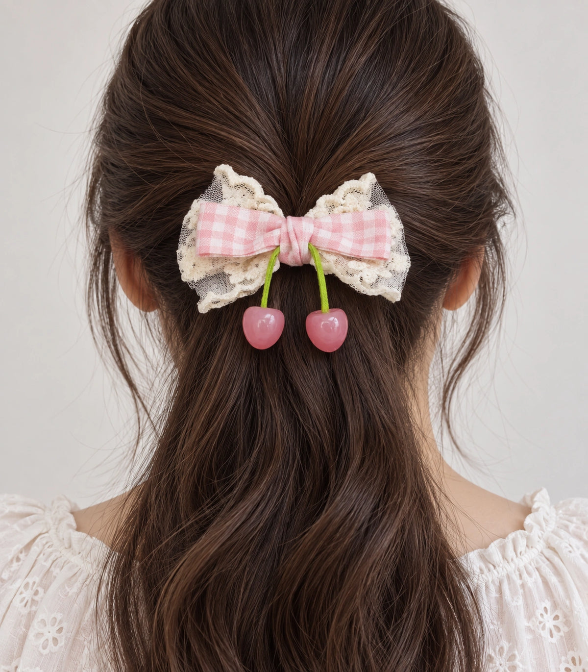 JIMIKI Pink Gingham Lace Bow Hair Clip with Cherry Charms in Pink, model wearing view