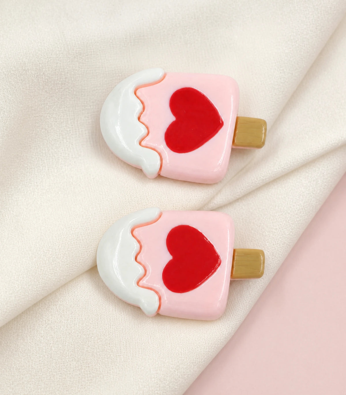 Editorial flat lay of the Pink Heart Frosted Popsicle Clip Pair