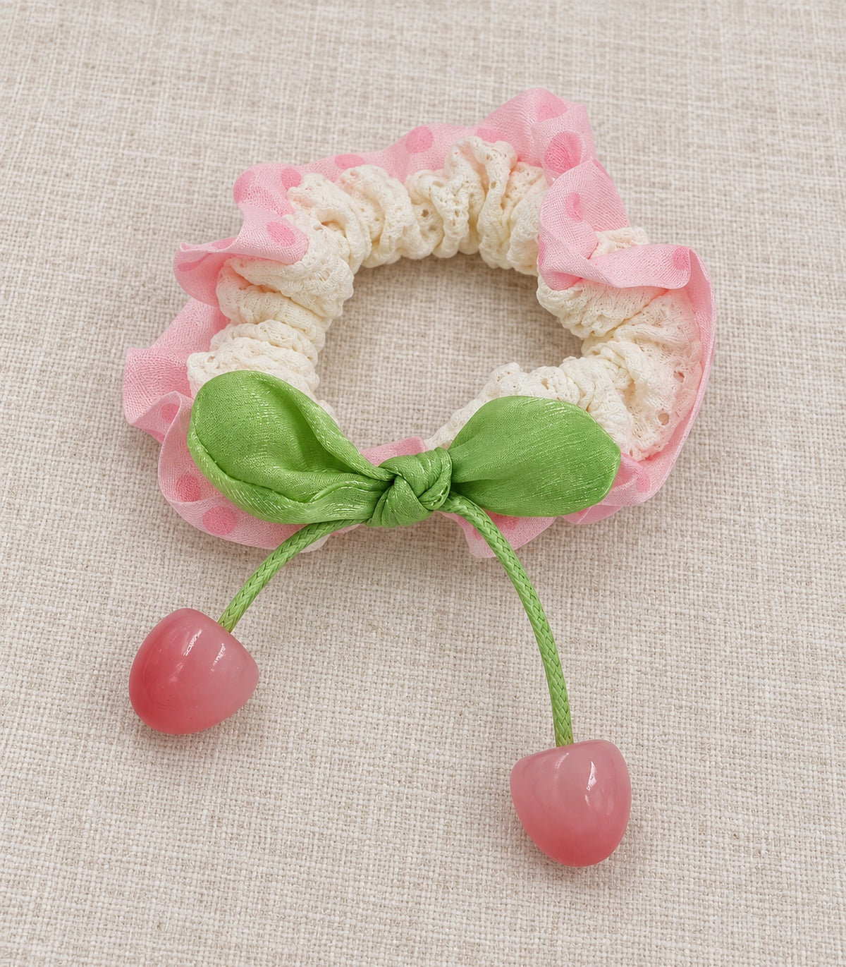 JIMIKI Polka Dot Lace Scrunchie With Cherry Charms in Pink, editorial flat lay #color_pink