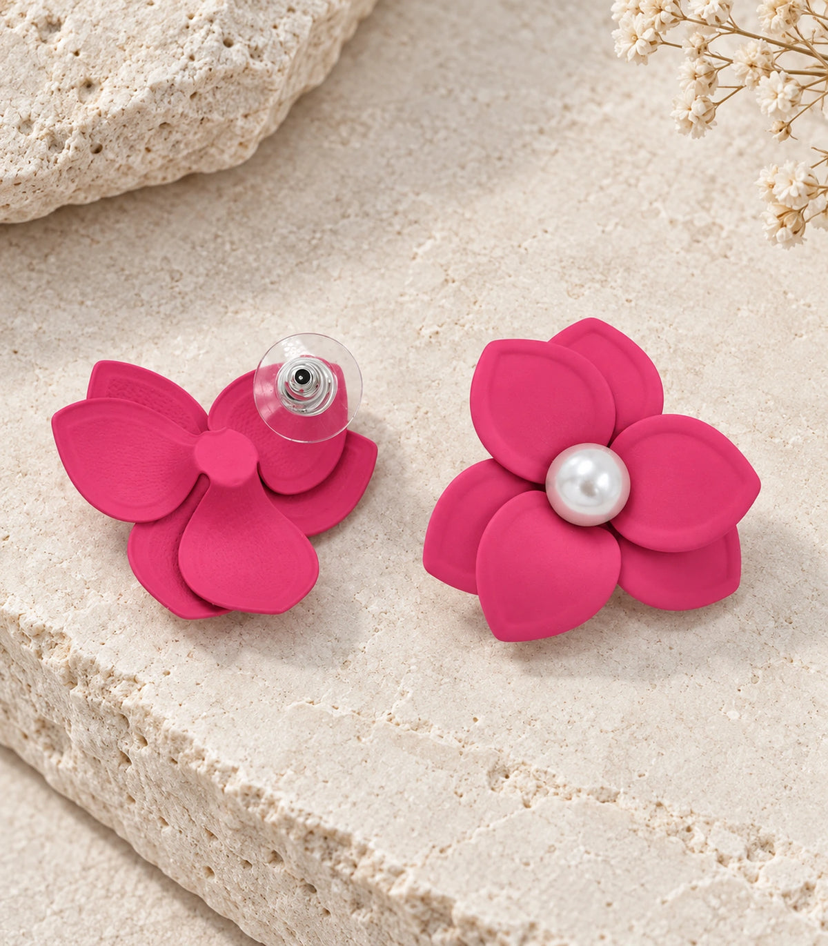 JIMIKI Pink Triple Petal Pearl Flower Stud Earrings - pair in styled flat lay #color_pink
