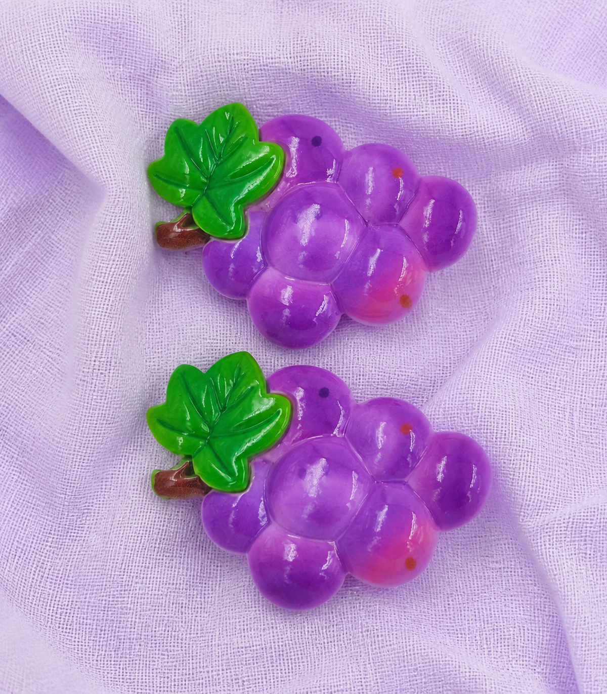 Purple Grape Barrette Pair editorial flat lay