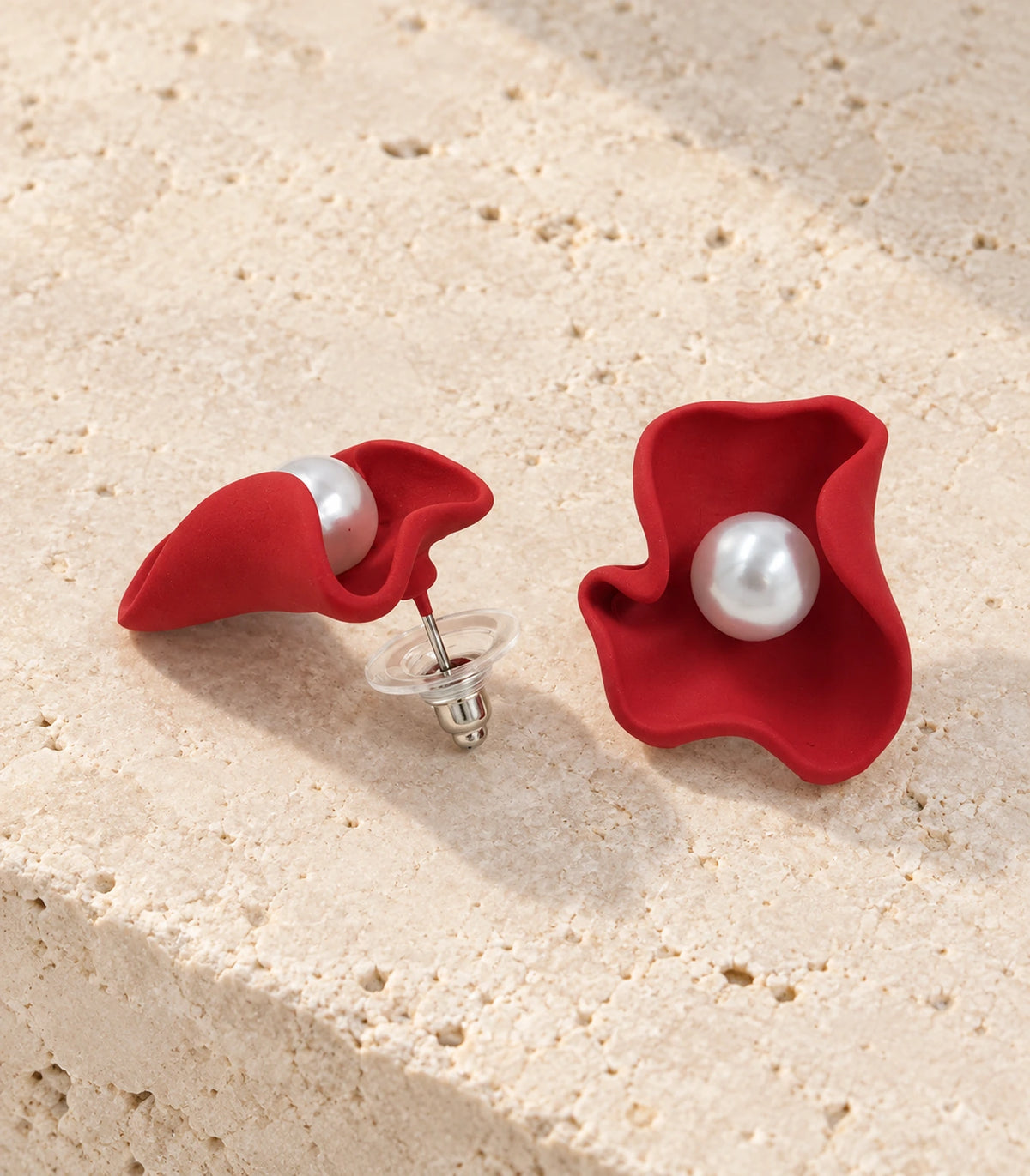 JIMIKI Folded Calla Pearl Stud Earrings, Red — pair in a styled flat lay #color_red