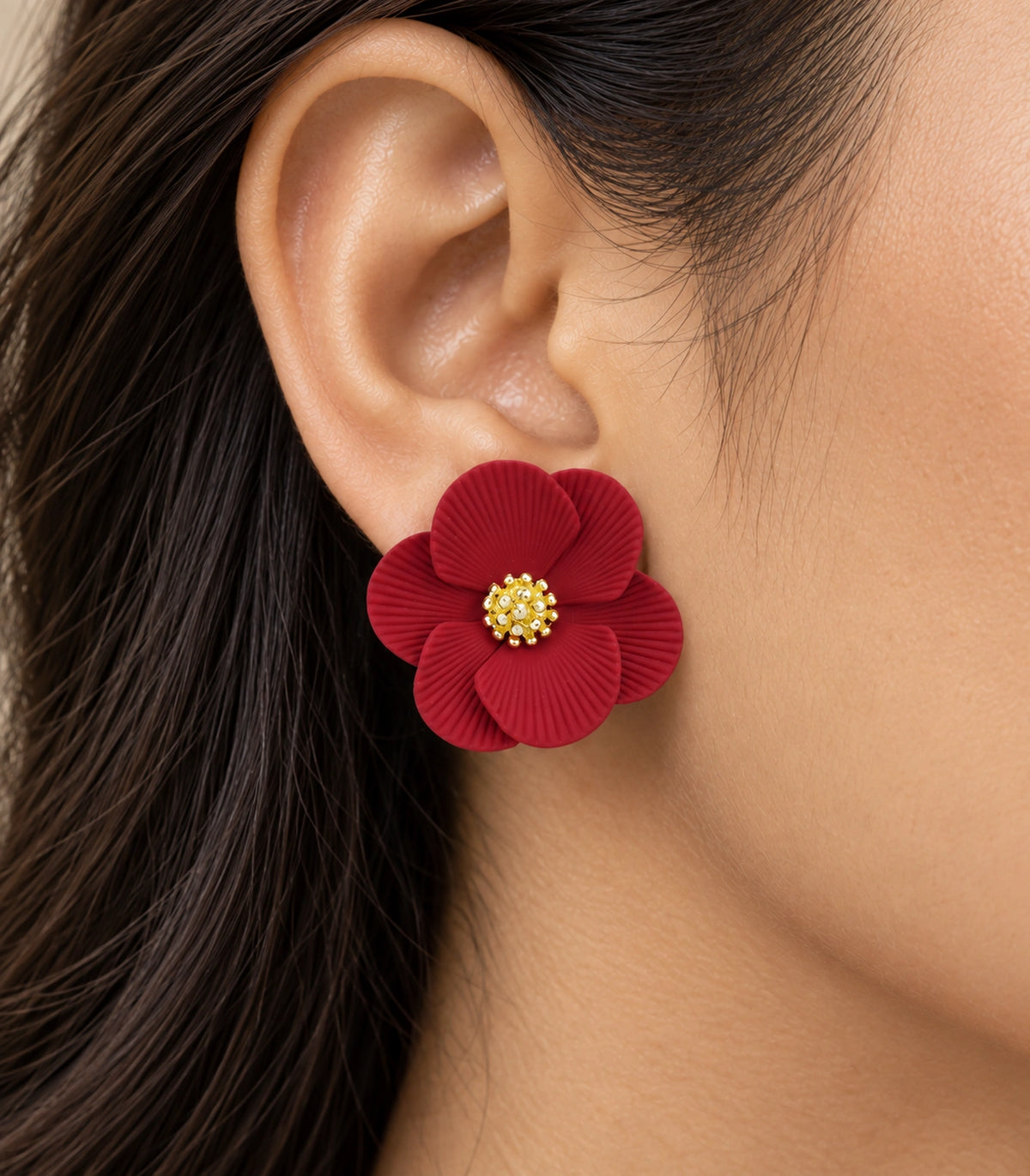 JIMIKI Red ribbed flower stud earrings, worn closeup of ribbed petals and gold-tone centre #color_red