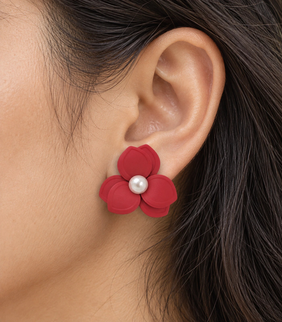 JIMIKI Red Triple Petal Pearl Flower Stud Earrings - layered petals and pearl-style centre worn close-up #color_red