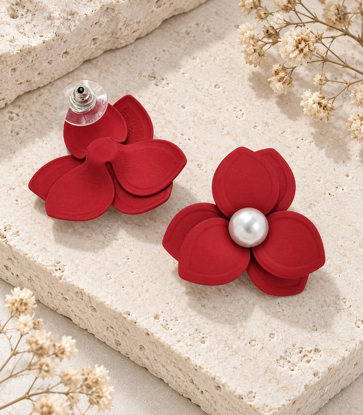JIMIKI Red Triple Petal Pearl Flower Stud Earrings - pair in styled flat lay #color_red