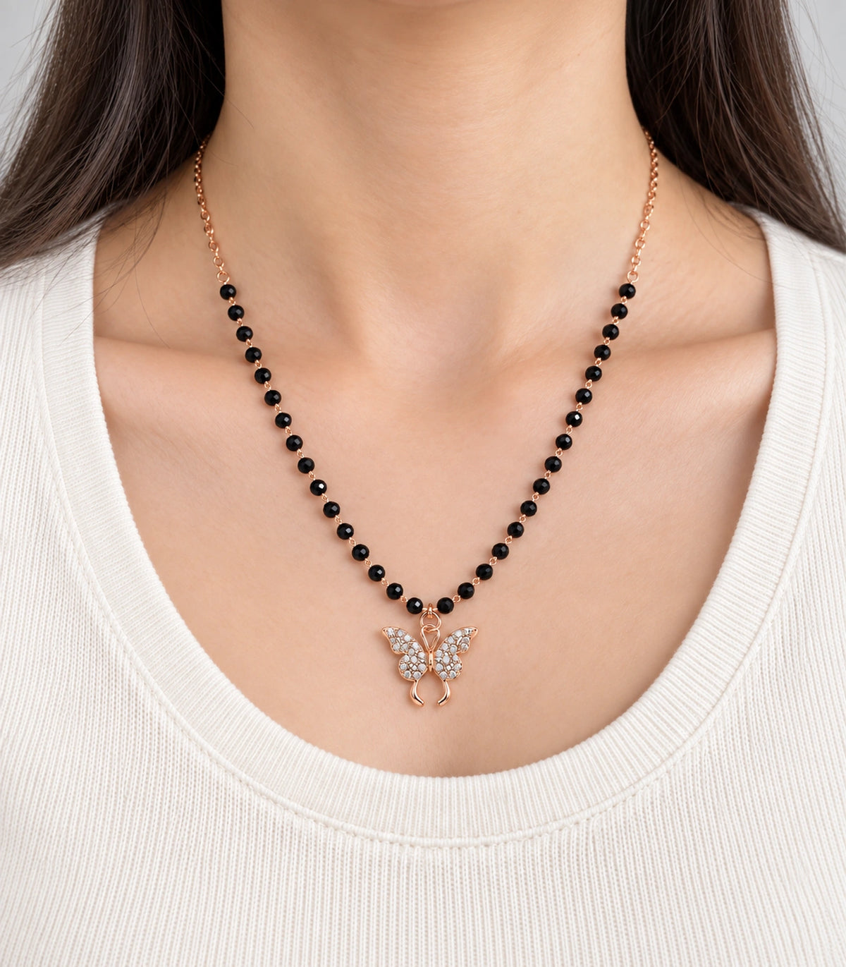 JIMIKI Rose-Gold Black-Bead Crystal Butterfly Necklace in Rose Gold / Black - close-up details #color_rose-gold-black