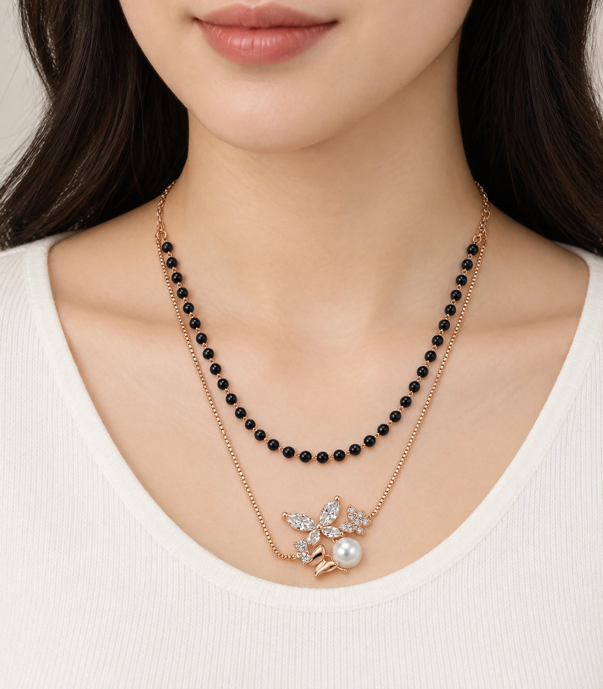 JIMIKI Rose-Gold Black-Bead Crystal-Butterfly Pearl Layered Necklace in Rose Gold / Black - worn styling view #color_rose-gold-black