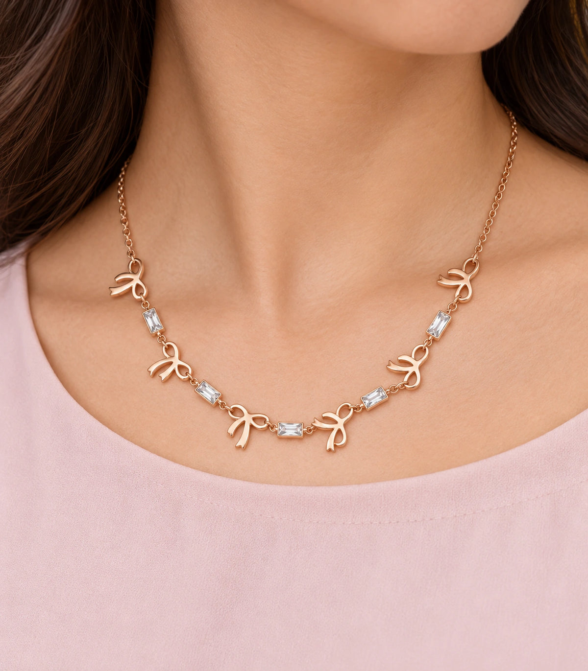 JIMIKI Rose Gold Bow Baguette Crystal Necklace in Rose Gold - close-up details #color_rose-gold