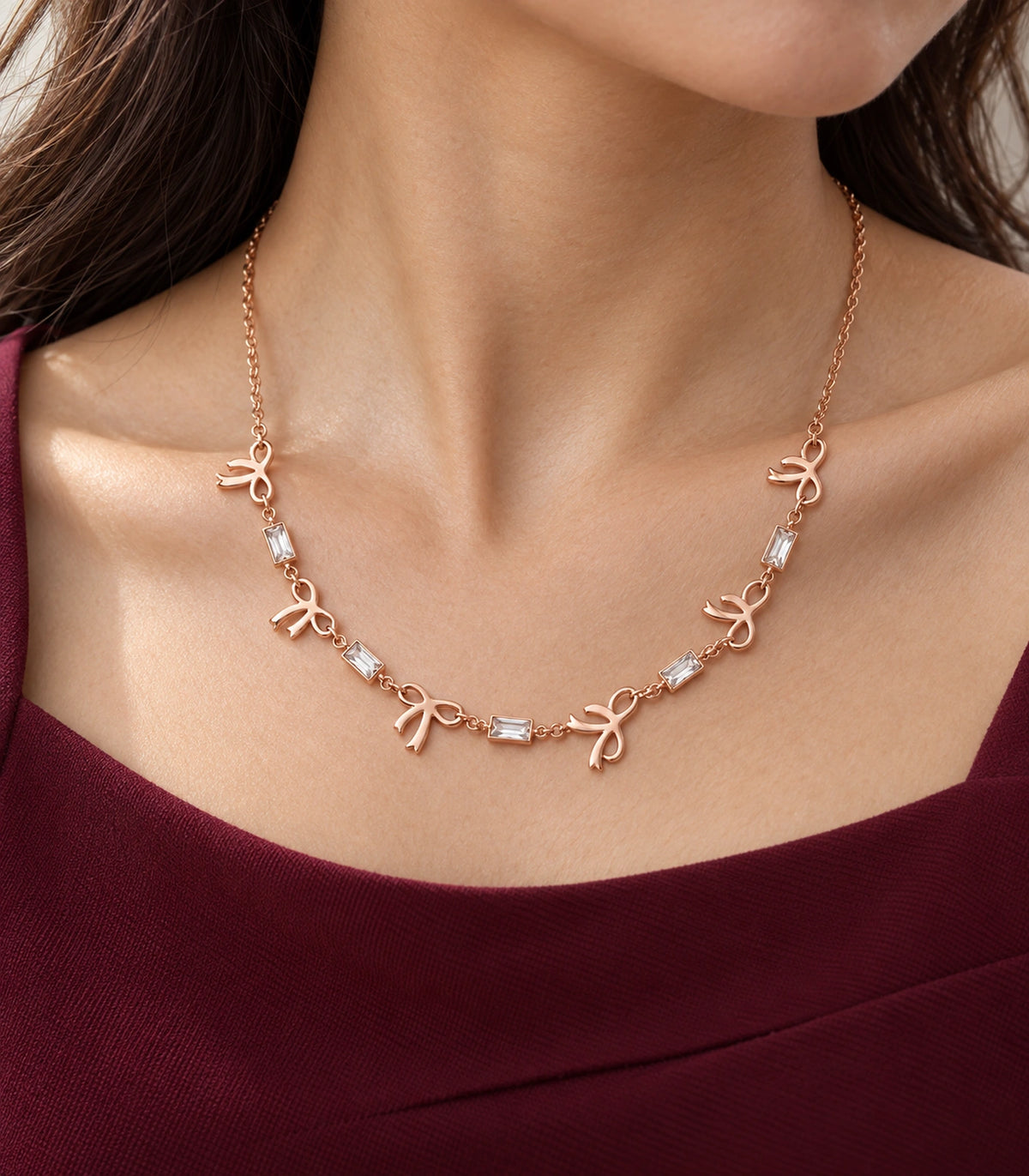 JIMIKI Rose Gold Bow Baguette Crystal Necklace in Rose Gold - editorial worn view #color_rose-gold