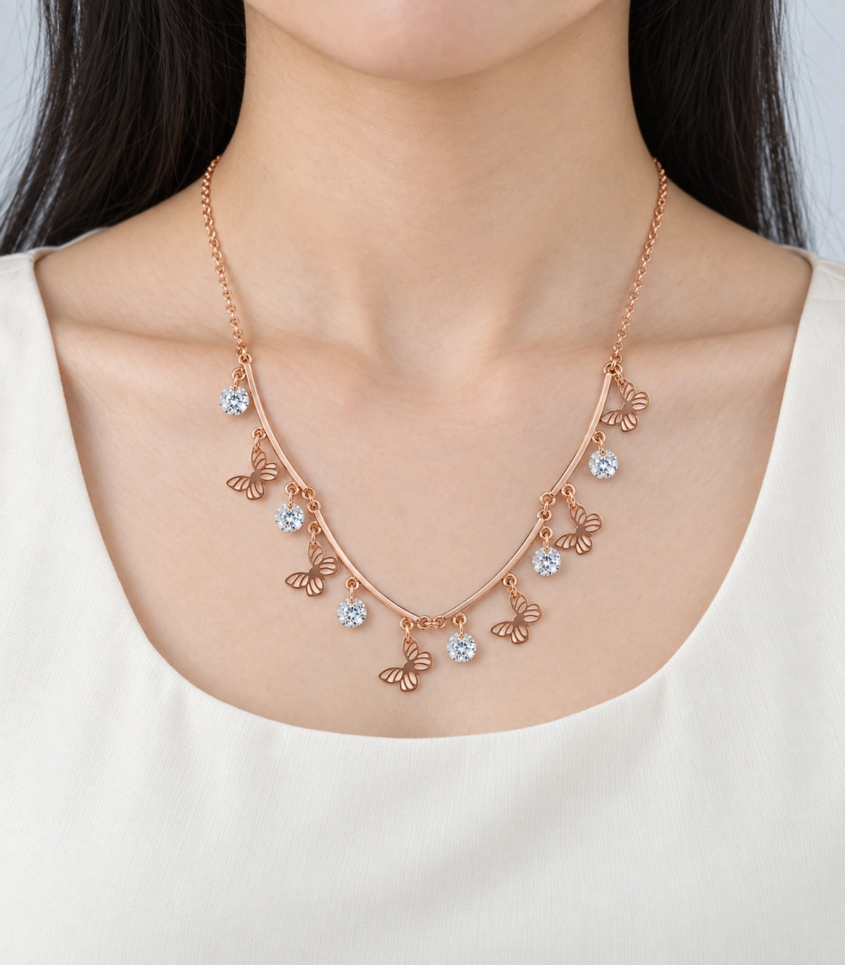 JIMIKI Rose Gold Butterfly Crystal Charm Collar Necklace in Rose Gold - worn styling view #color_rose-gold