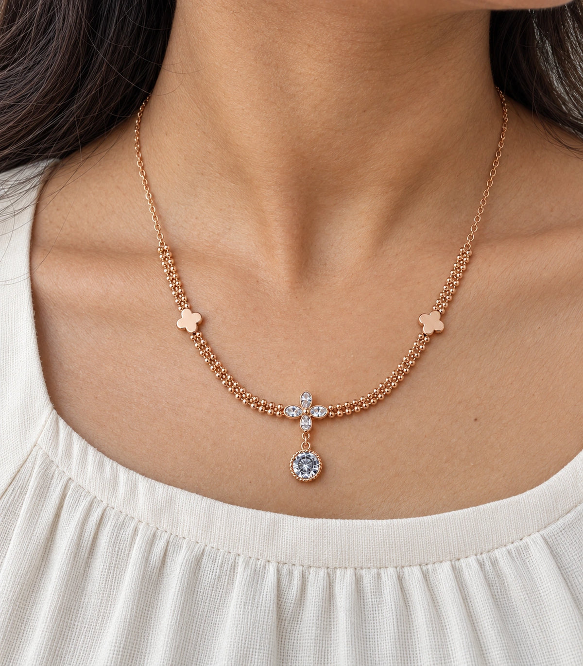 JIMIKI Clover Crystal Flower Drop Necklace in Rose Gold - close-up details #color_rose-gold