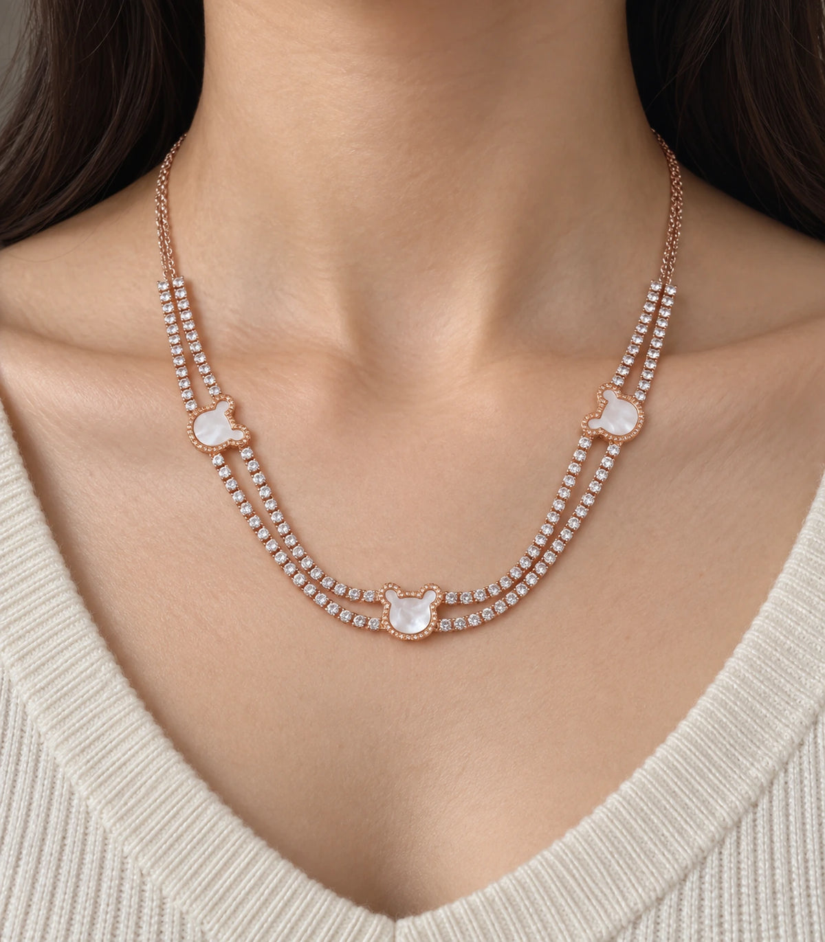 JIMIKI rose-gold-tone double-strand motif necklace, close-up of the clear stones and pearly white motifs #color_rose gold