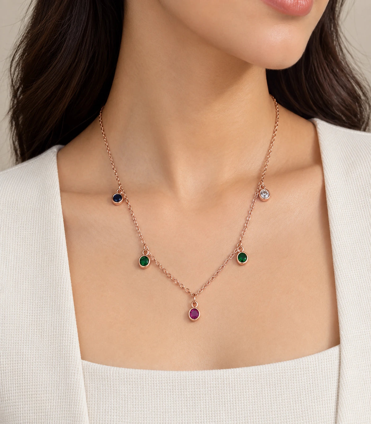 JIMIKI Rose Gold Multicolor Five-Stone Station Necklace, necklace worn with a cream neckline in warm light #color_multicolour