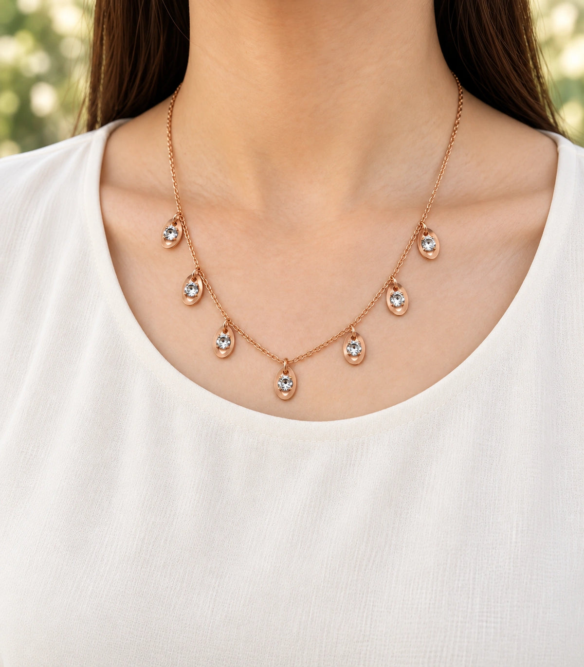 JIMIKI Rose Gold Oval Crystal Charm Necklace in Rose Gold - editorial worn view #color_rose-gold