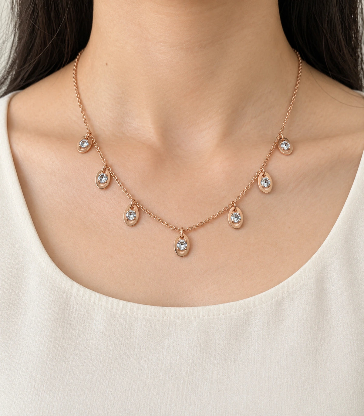 JIMIKI Rose Gold Oval Crystal Charm Necklace in Rose Gold - worn styling view #color_rose-gold