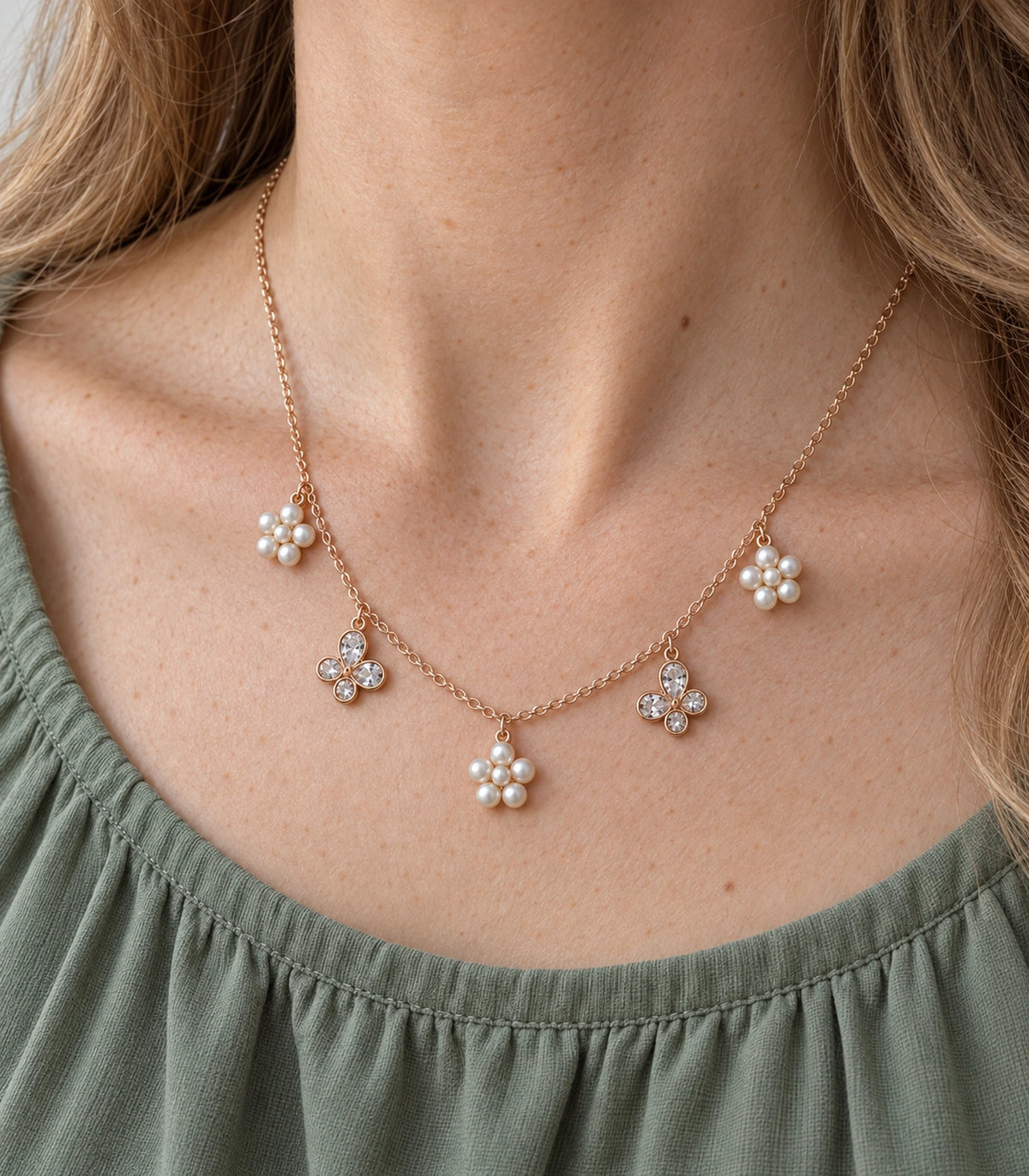 JIMIKI Rose Gold Pearl Flower Crystal Butterfly Necklace in Rose Gold - close-up details #color_rose-gold
