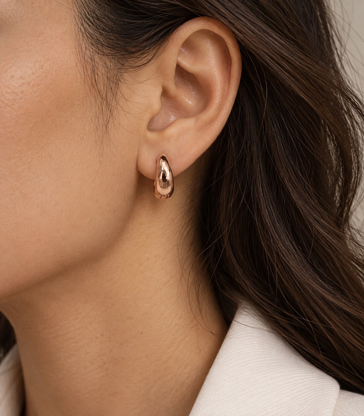 JIMIKI Smooth Tapered Huggie Earrings in Rose Gold Tone — editorial worn styling #color_rose-gold-tone