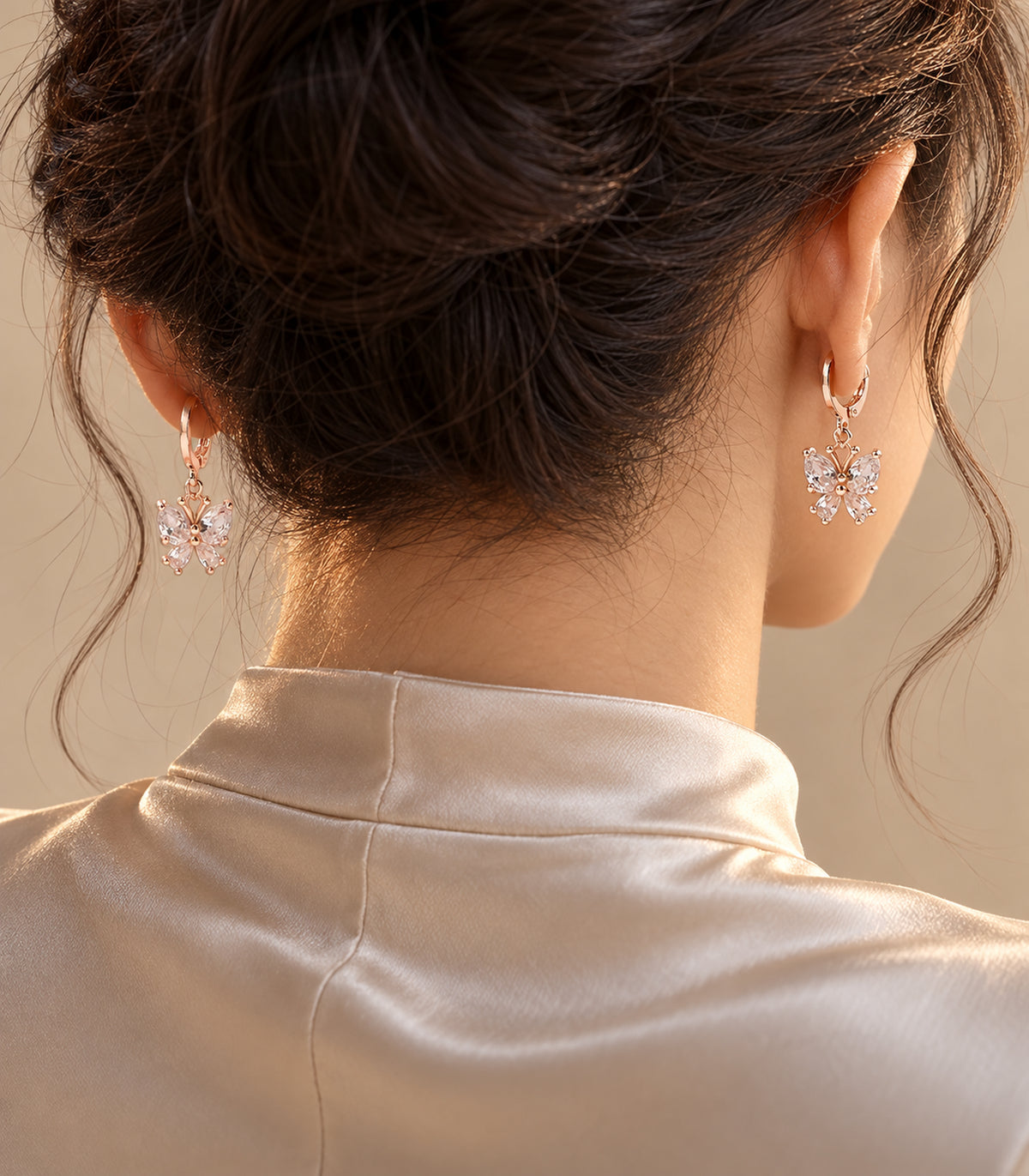 Editorial worn view of a matching pair from the rose gold tone hoop earring set