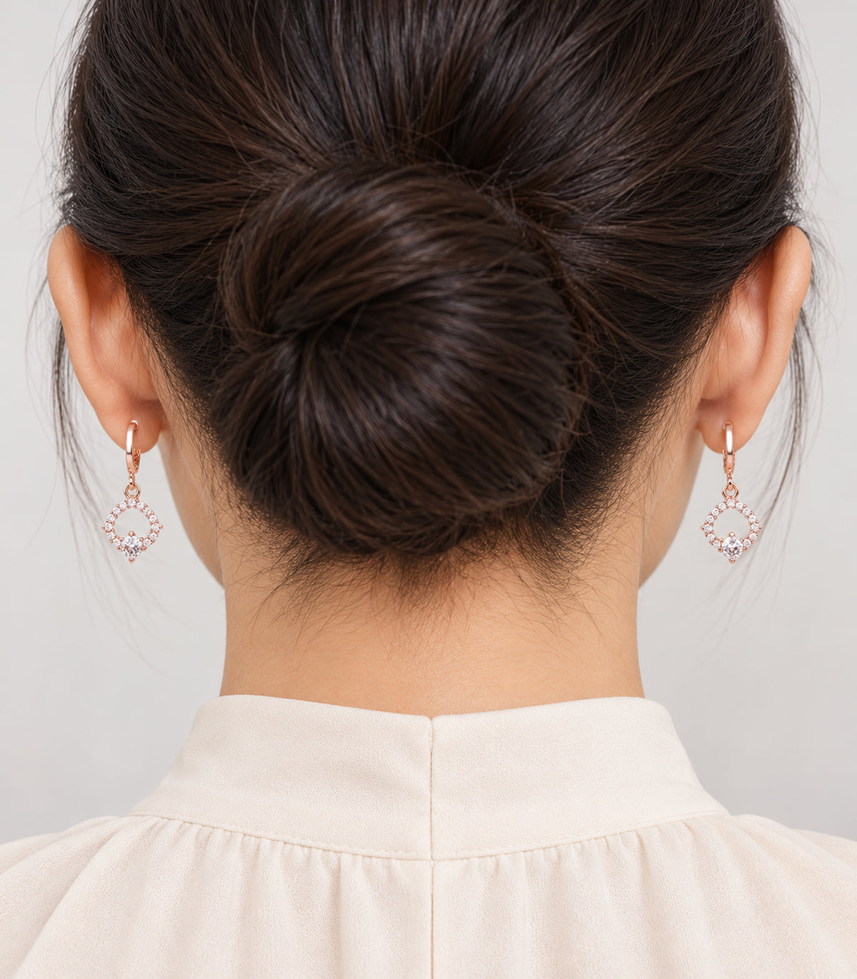 Rose Gold Tone Three-Pair Geometric Crystal Hoop Earring Set — model showing one design from the set