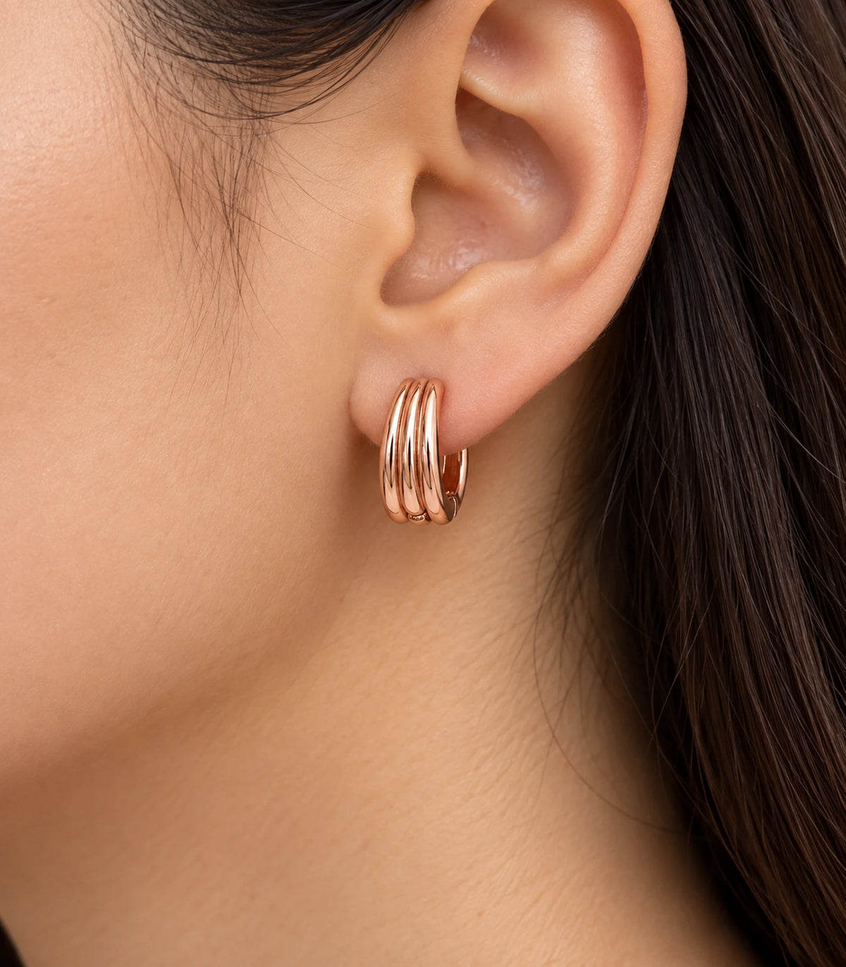 JIMIKI Triple-Ridge Huggie Hoop Earrings in Rose Gold Tone - model #color_rose-gold-tone