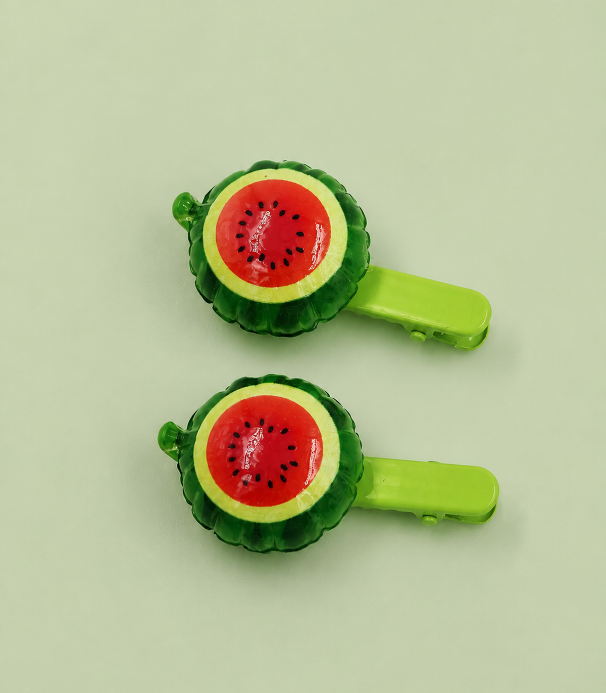 Round Watermelon Barrette Pair editorial flat lay