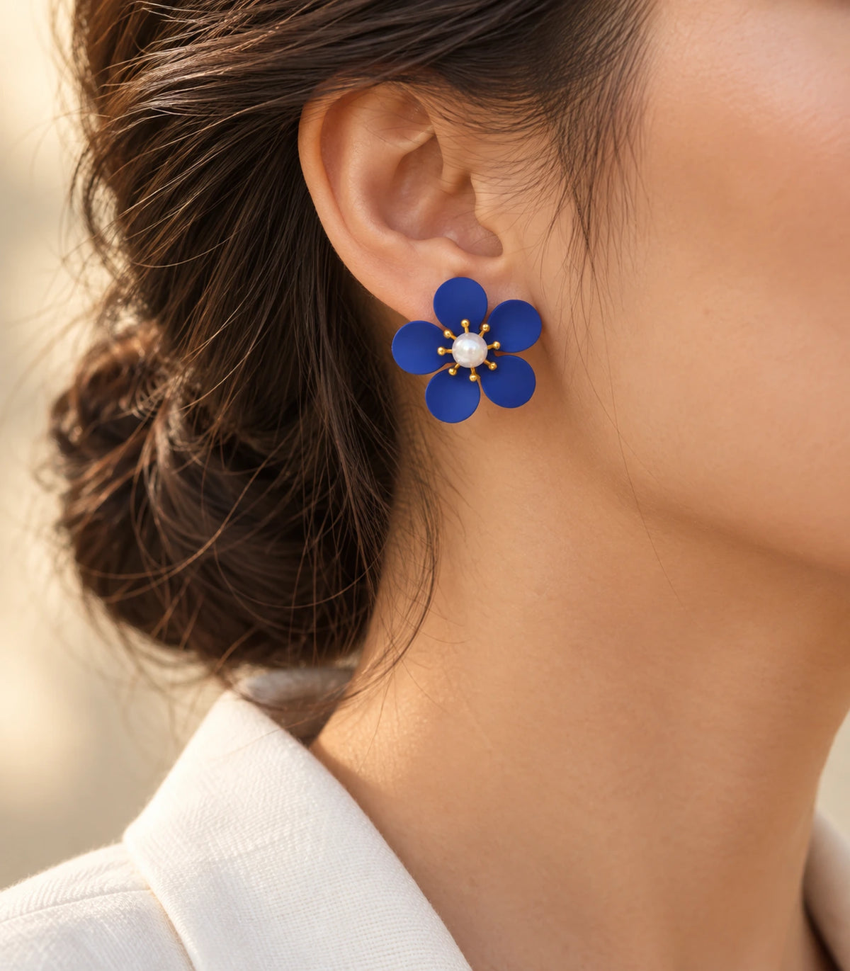 JIMIKI royal blue five-petal flower stud earrings with pearl-effect centre, alternate styled worn view of flower stud #color_royal-blue
