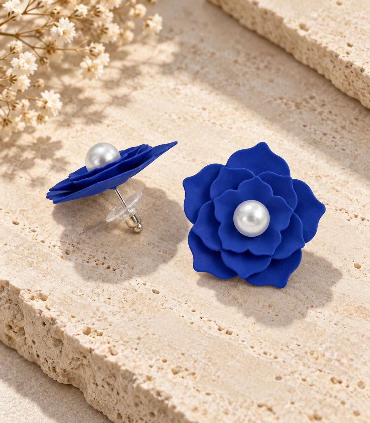 JIMIKI Layered Flower Pearl Stud Earrings, Royal Blue — pair in a styled flat lay #color_royal blue