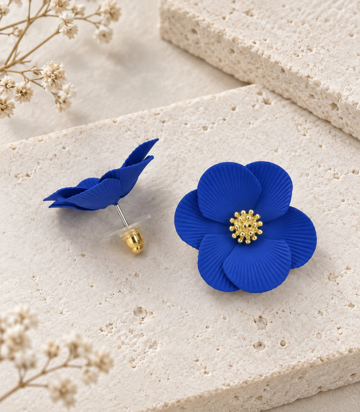 JIMIKI Royal Blue ribbed flower stud earrings, pair arranged in an editorial flat lay #color_royal blue