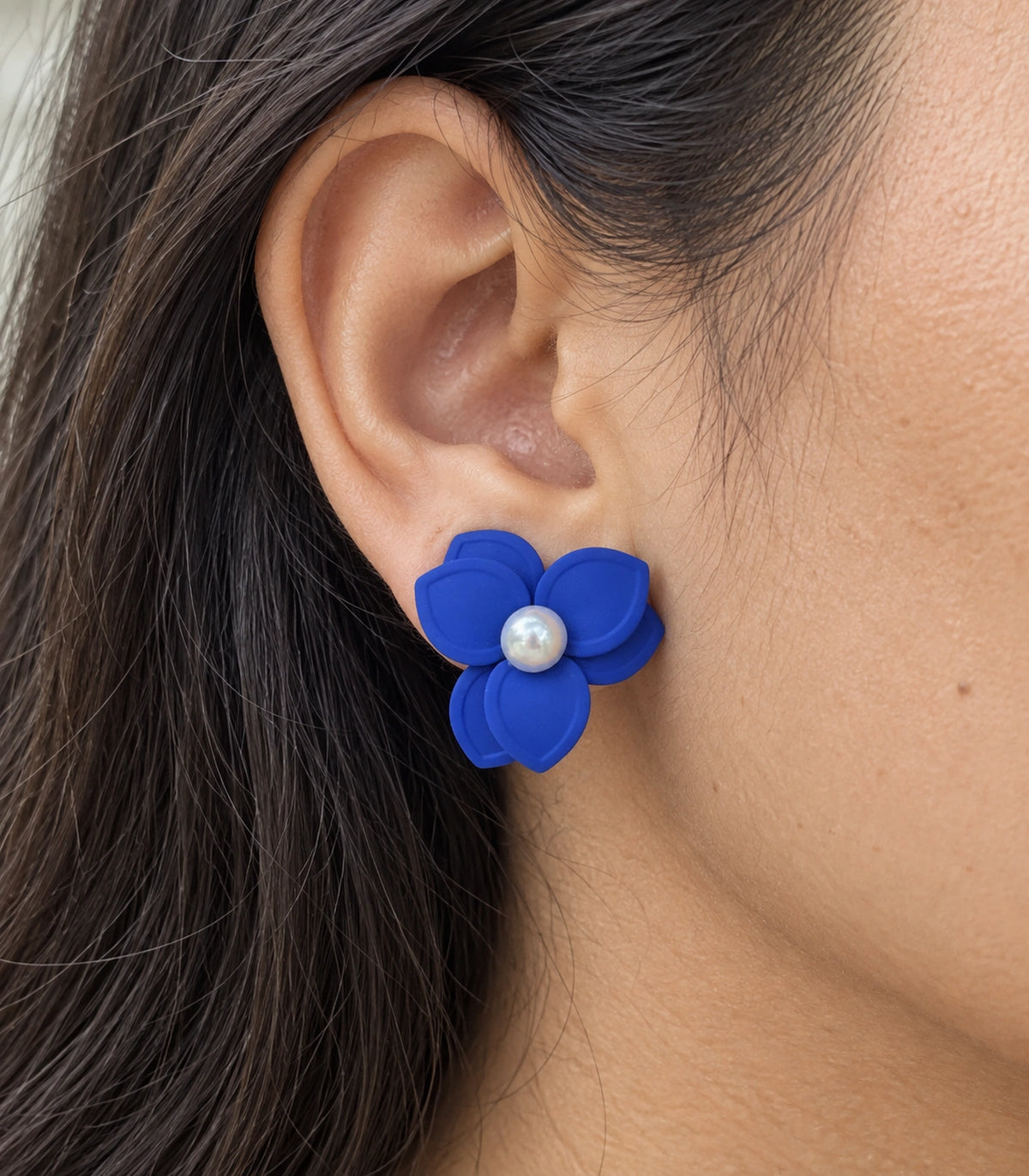 JIMIKI Royal Blue Triple Petal Pearl Flower Stud Earrings - layered petals and pearl-style centre worn close-up #color_royal blue
