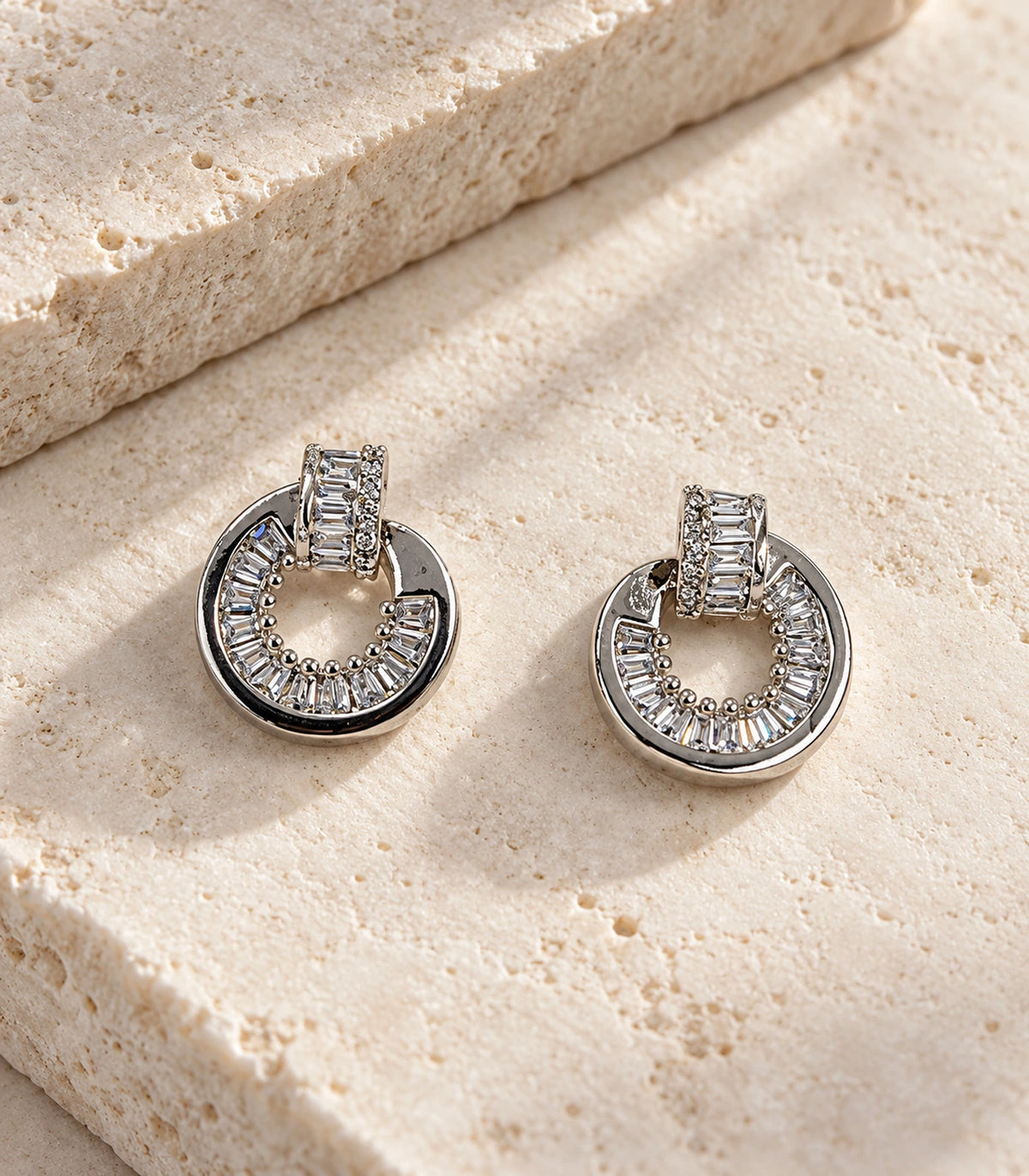 Silver Baguette Halo Circle Earrings matching pair in editorial flatlay