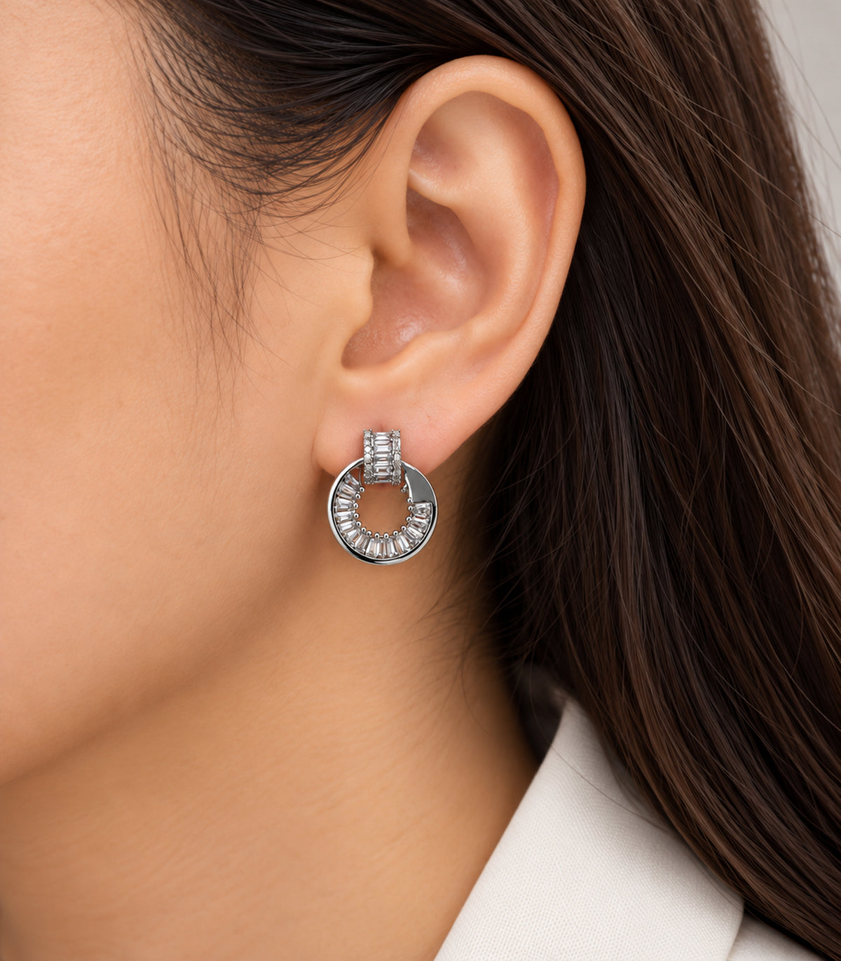 Silver Baguette Halo Circle Earrings worn on one ear with ivory blouse