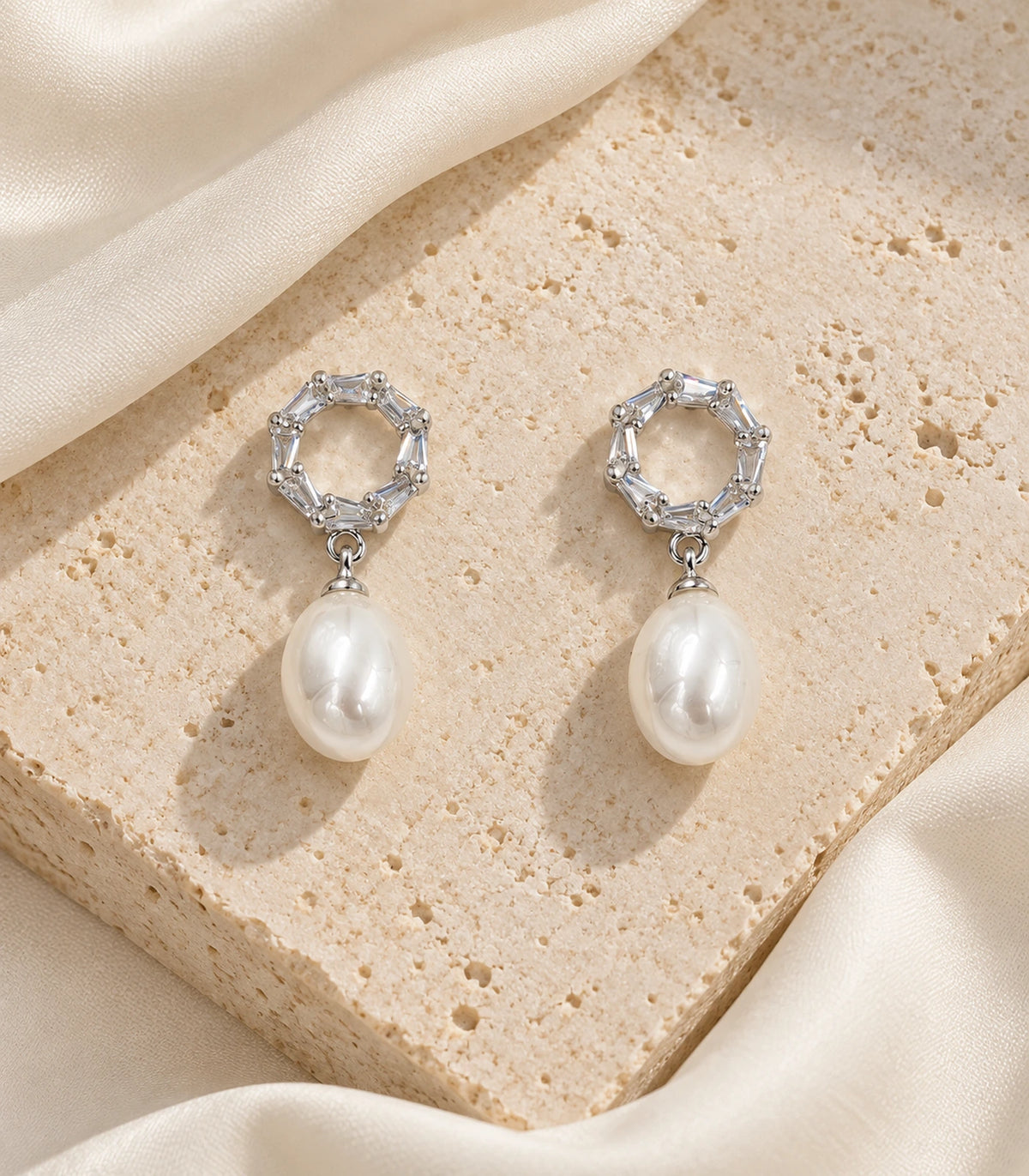 JIMIKI Silver Baguette Halo Pearl Drop Earrings, editorial flatlay pair #color_silver