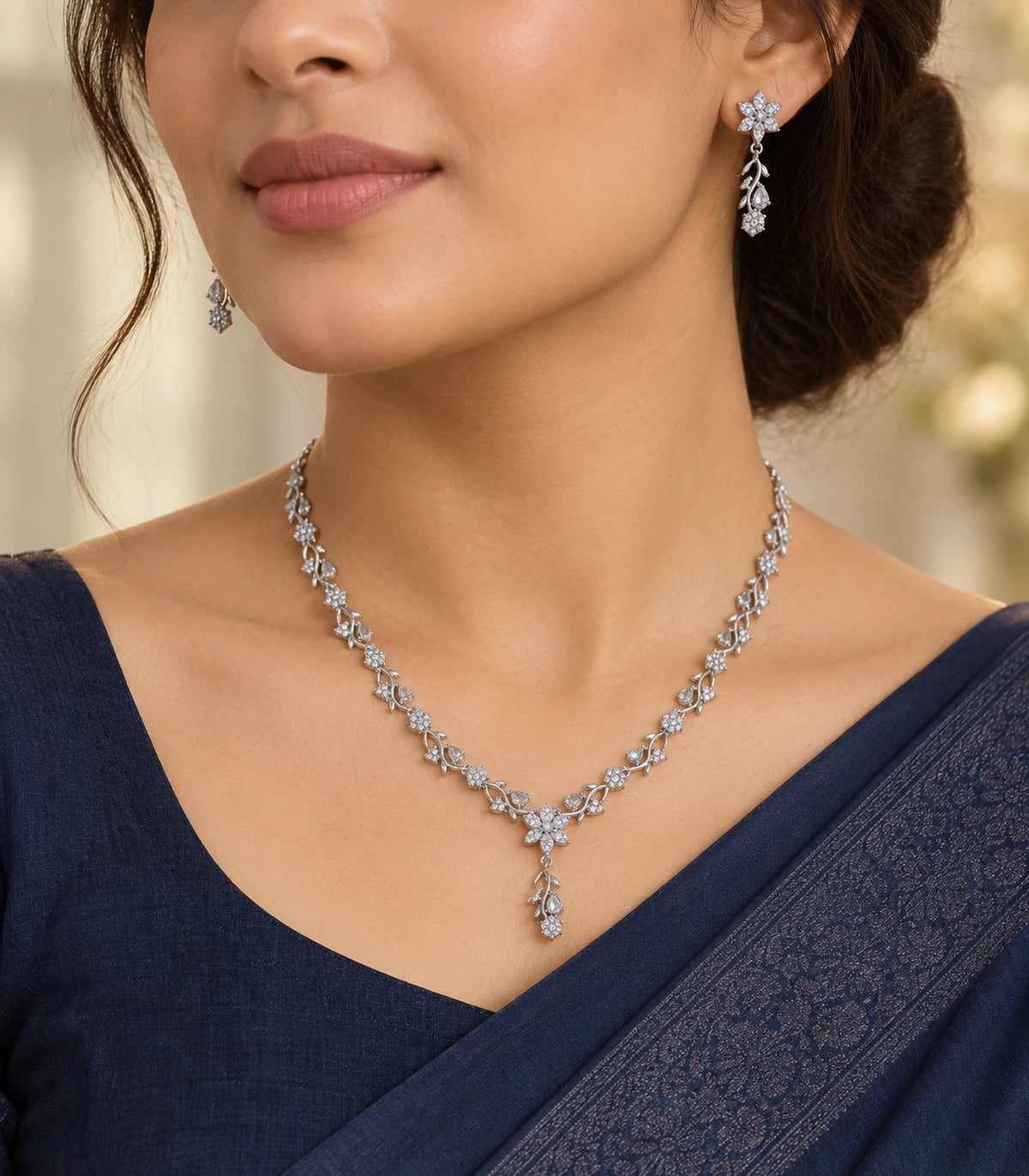 Silver-tone clear floral Y-drop necklace set styled with a navy saree
