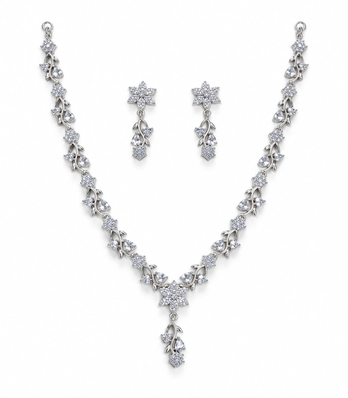 Silver-tone clear floral Y-drop necklace with two matching floral drop earrings on white