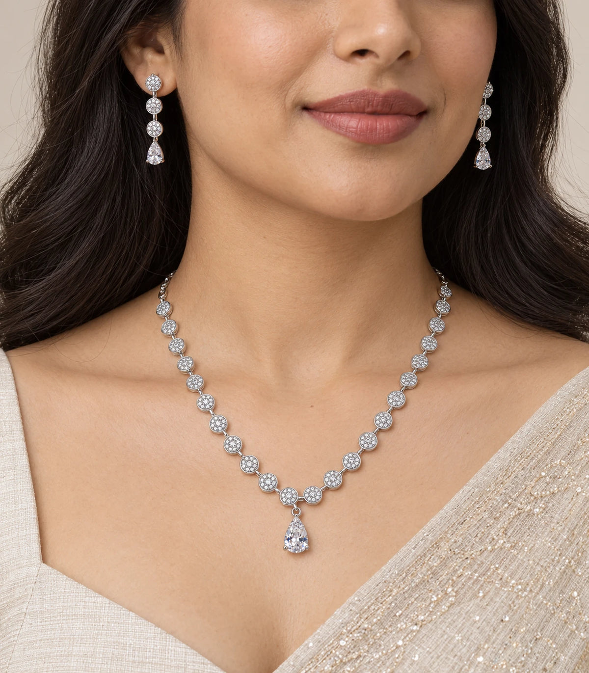 Silver clear round crystal drop necklace set and matching earrings worn with an ivory outfit