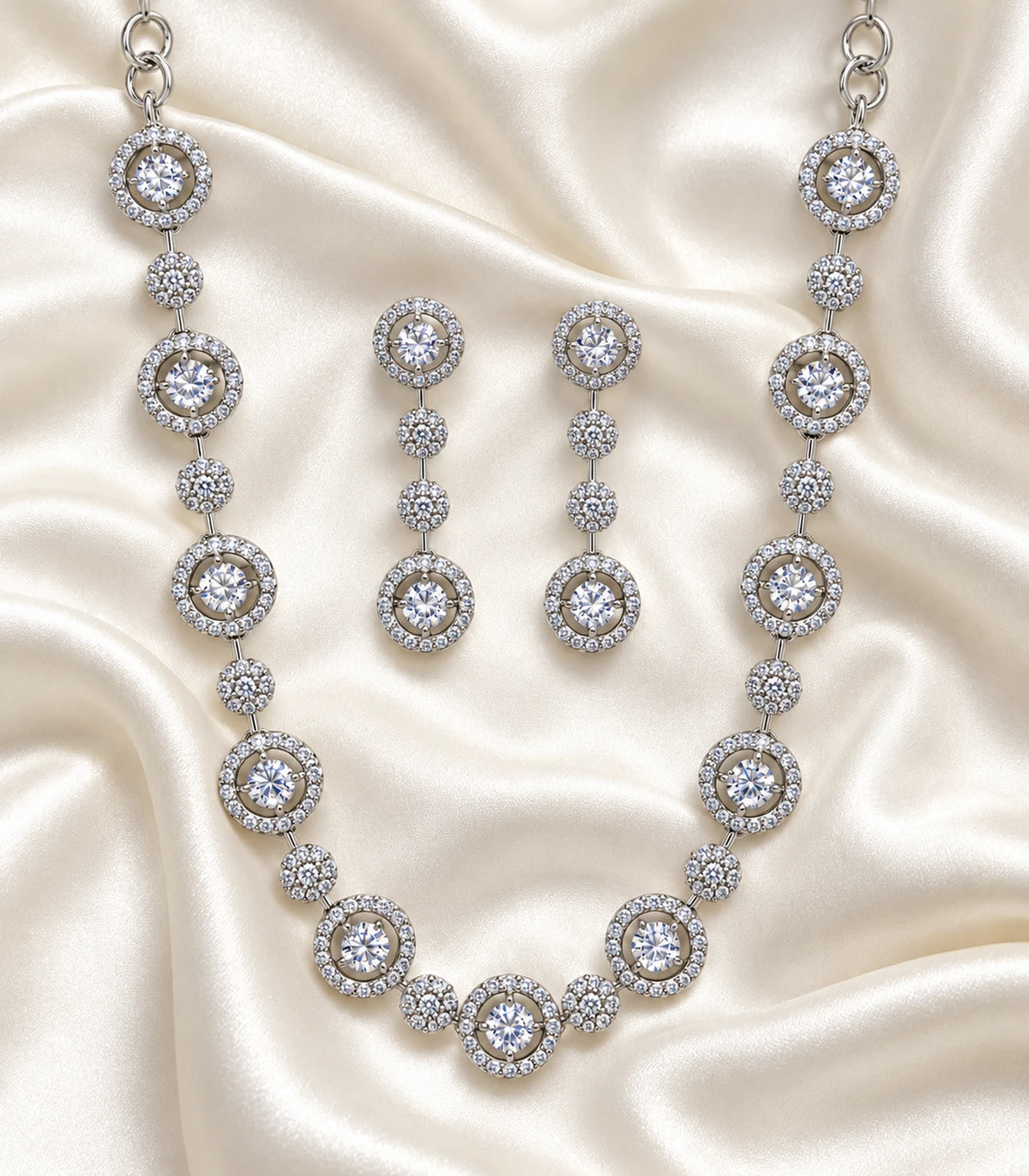 Silver Clear Round Crystal Necklace Set with necklace and matching earring pair on ivory fabric