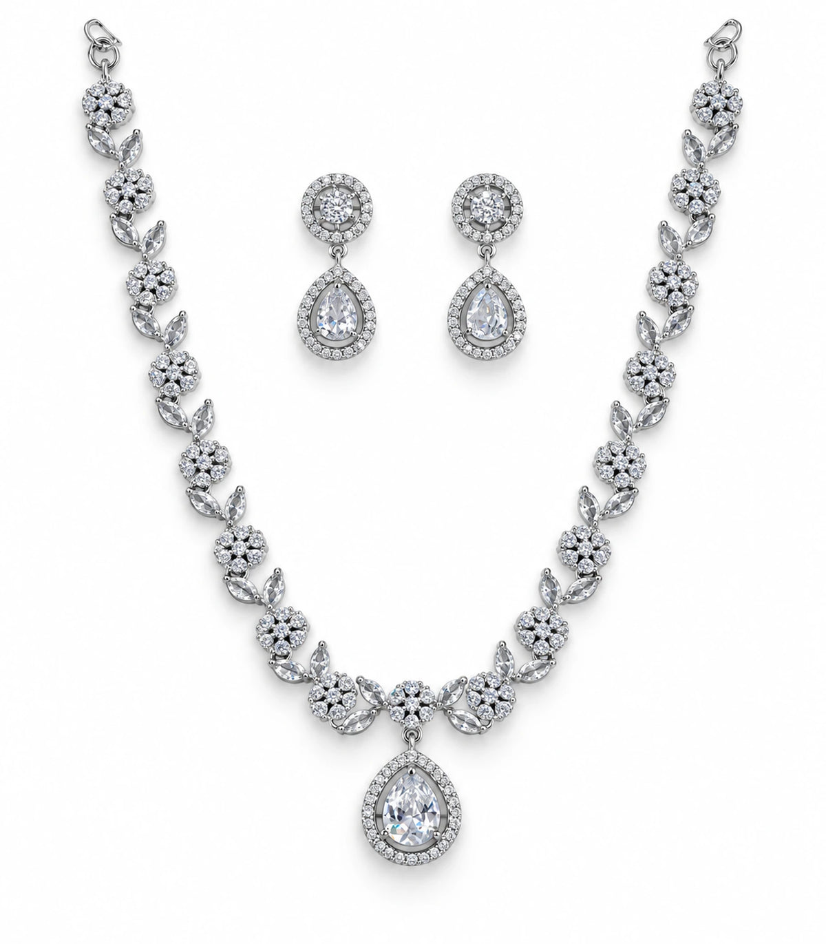 Silver clear crystal necklace set with floral links, teardrop pendant and matching pair of earrings on white