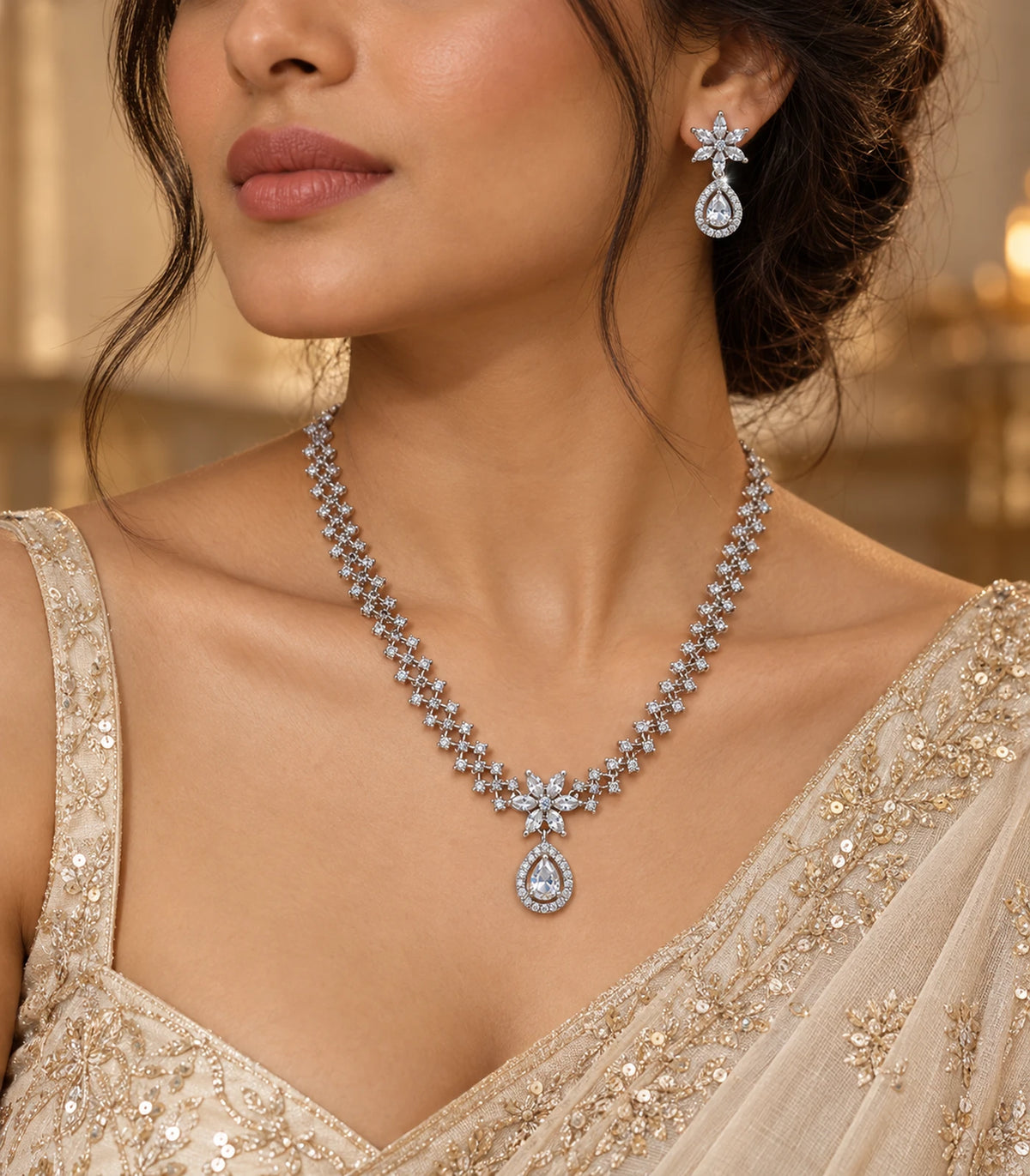 Angled styling view of silver clear star teardrop necklace and matching earring